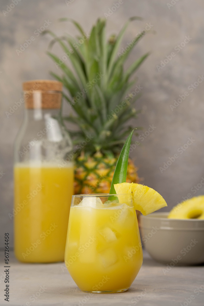 Fototapeta premium Pineapple cocktail in glass jars on wooden table closeup