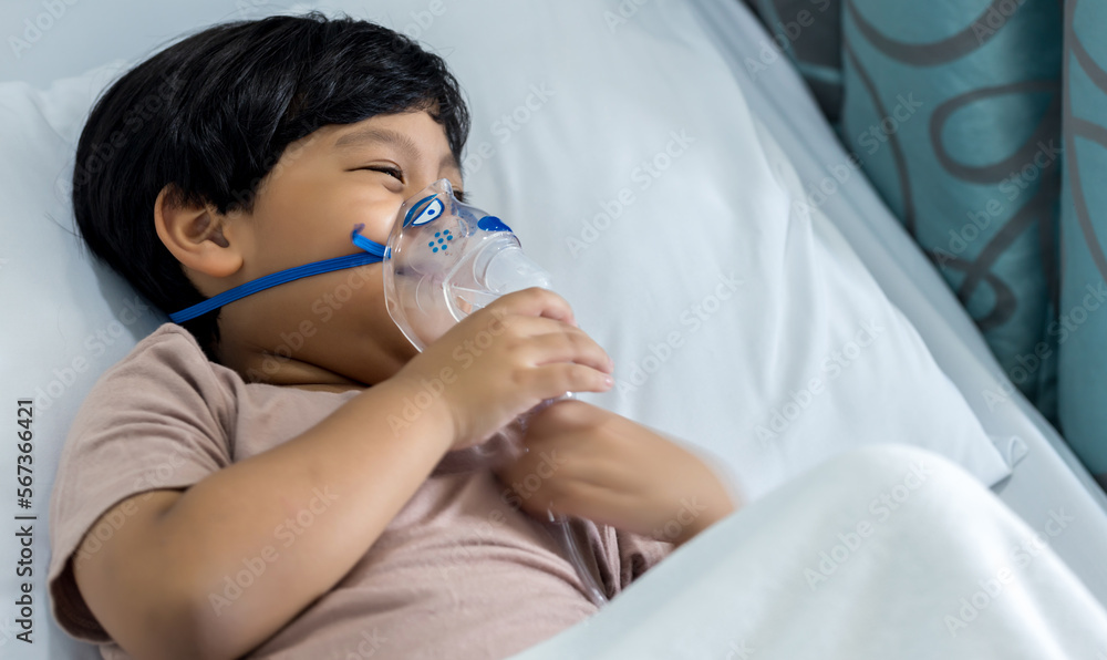 Sick boy inhalation therapy by the mask of inhaler. Baby has asthma and need nebulizations. Patient Boy use inhalation with Nebulizer mask at hospital. The baby are spraying bronchodilators . Sick boy inhalation therapy by the mask of inhaler. Baby has asthma and need nebulizations. Patient Boy use inhalation with Nebulizer mask at hospital. The baby are spraying bronchodilators .
