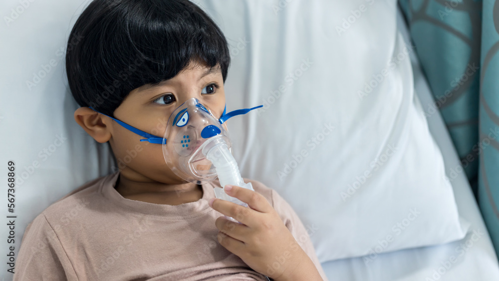 Sick boy inhalation therapy by the mask of inhaler. Baby has asthma and need nebulizations. Patient Boy use inhalation with Nebulizer mask at hospital. The baby are spraying bronchodilators . Sick boy inhalation therapy by the mask of inhaler. Baby has asthma and need nebulizations. Patient Boy use inhalation with Nebulizer mask at hospital. The baby are spraying bronchodilators .
