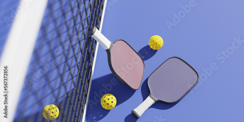 Rackets and balls for playing pickleball at the sports net on the court. 3D rendering photo