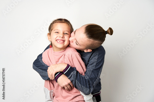 Boy and girl hugging each other on white background