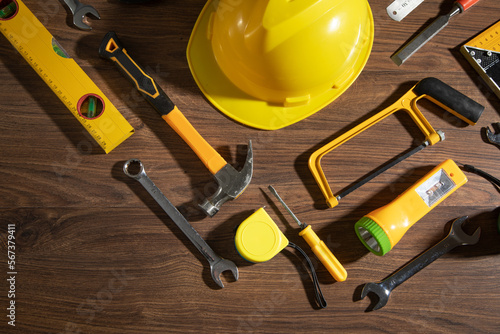 Work tools with helmet on wooden background. © andranik123