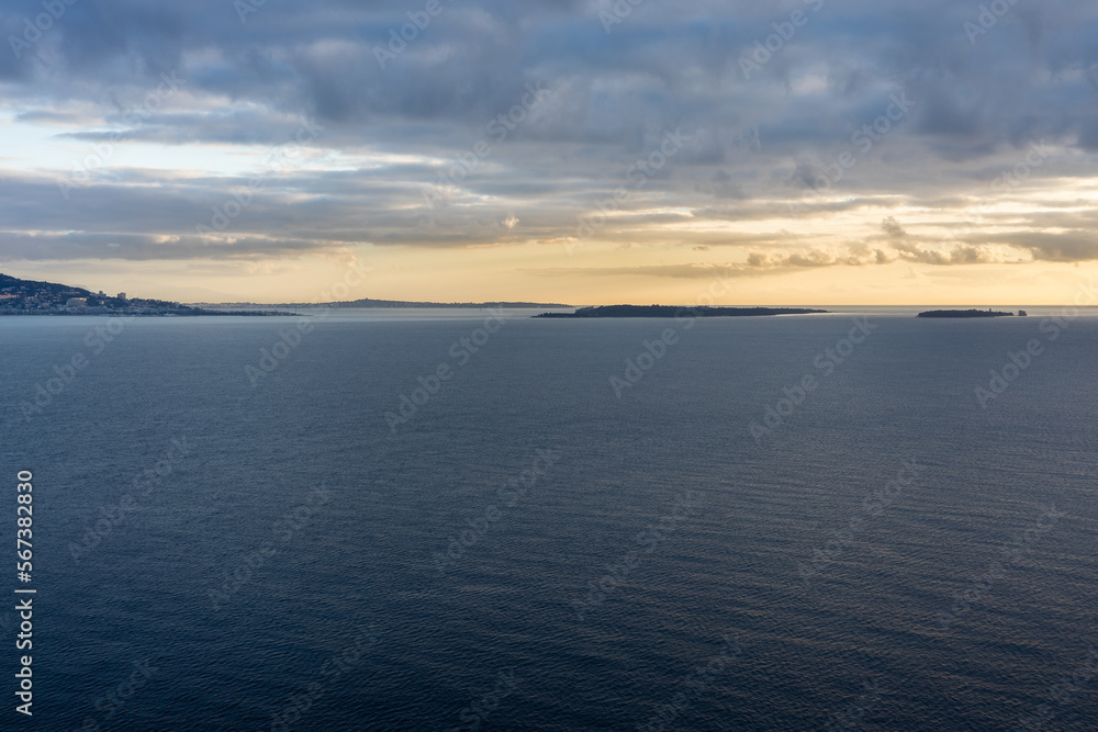 Fototapeta premium Sunrise over bay of Cannes with Cap d'Antibes and Iles de Lerins, France
