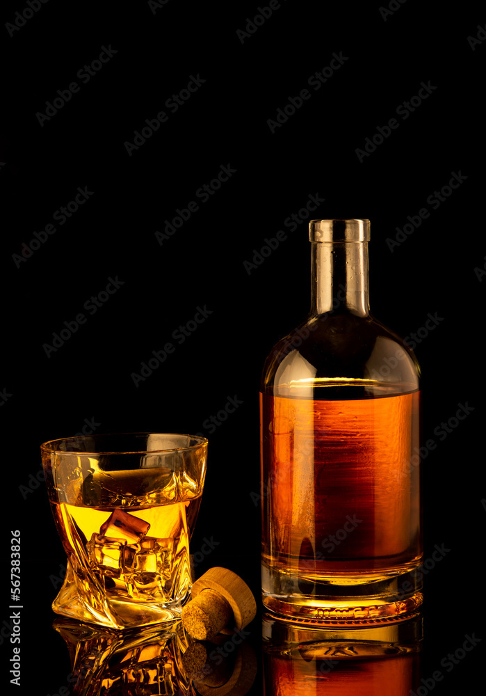 Golden alcoholic drink in decanter, bottle and glass Golden alcoholic drink in decanter, bottle and glass