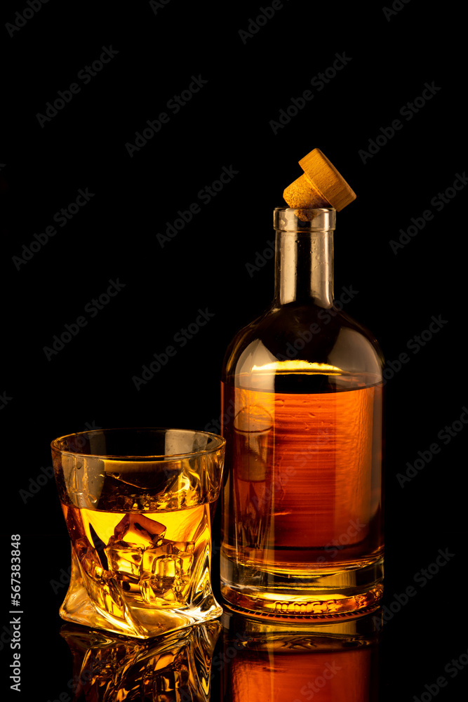 Golden alcoholic drink in decanter, bottle and glass Golden alcoholic drink in decanter, bottle and glass