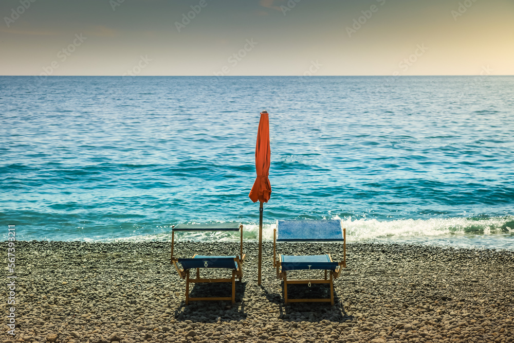 Positano secuded beach with chairs and parasol sunshade, amalfi coast, Italy