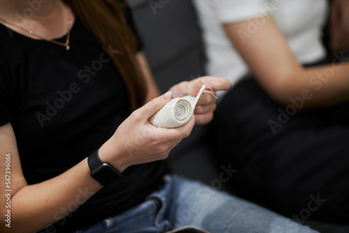 Elastic bandage in hands close-up. Hand bandaging process. First aid training for people. 