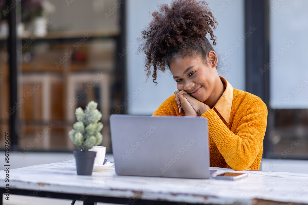 Portrait of Happy smiling african american businesswoman, adorable girl using laptop browsing web drinking coffee in cafe restaurant outdoors Portrait of Happy smiling african american businesswoman, adorable girl using laptop browsing web drinking coffee in cafe restaurant outdoors