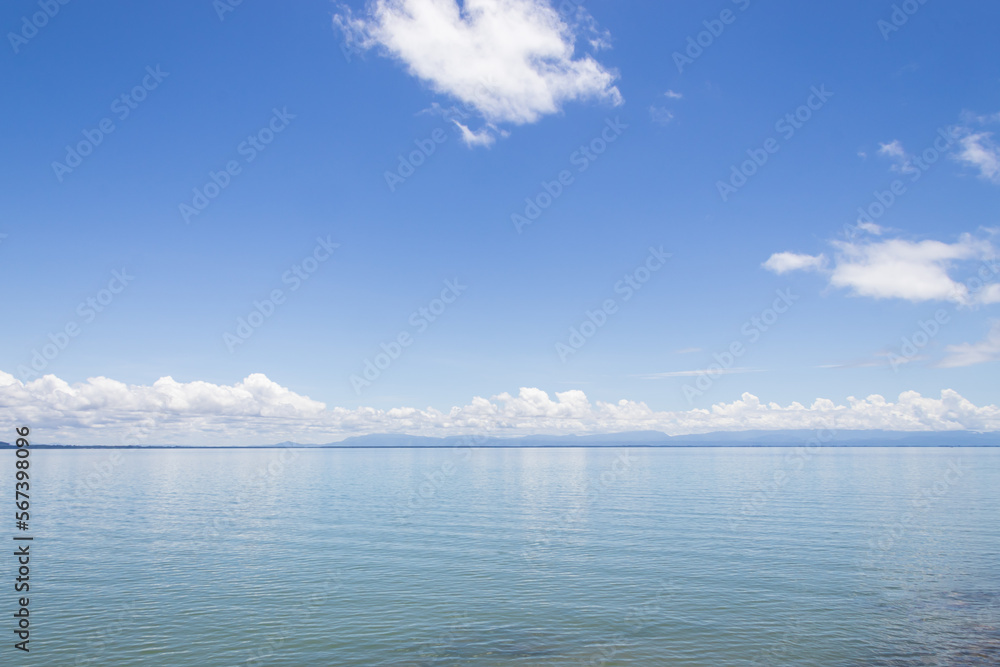 Morning sky and sea, bright white clouds, daytime, relaxing feeling, with copy space, suitable for use as a background image.