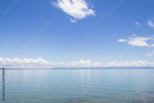 Morning sky and sea, bright white clouds, daytime, relaxing feeling, with copy space, suitable for use as a background image.