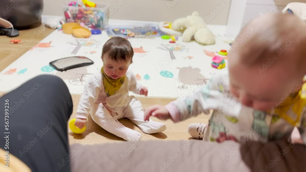 baby toddlers play in kindergarten on the floor. the teacher sings from the baby bottle baby in kindergarten. baby kids playing on the sofa in kindergarten lifestyle baby toddlers play in kindergarten on the floor. the teacher sings from the baby bottle baby in kindergarten. baby kids playing on the sofa in kindergarten lifestyle