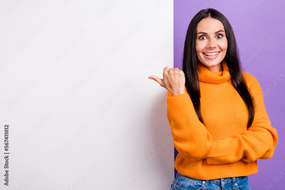 Photo of shocked positive lady promoter point billboard indicate advertisement isolated purple color background Photo of shocked positive lady promoter point billboard indicate advertisement isolated purple color background