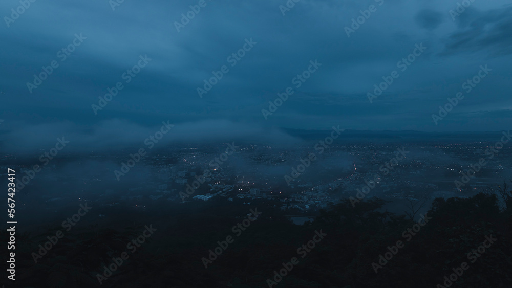 The mist drifted over the city in the evening before it fade away. Fog over the city, city in fog.