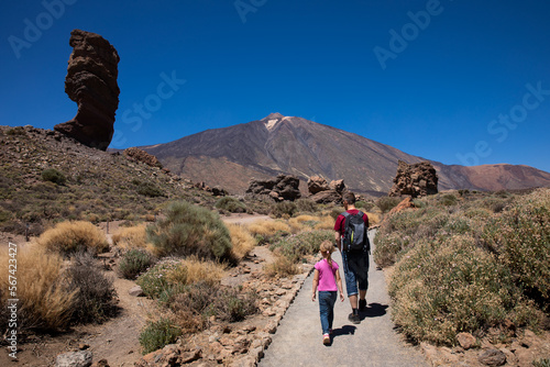 tourists and view of the peak of the Pico del Teide mountain volcano on a sunny day, Teide National Park, Tenerife, Canary Islands,