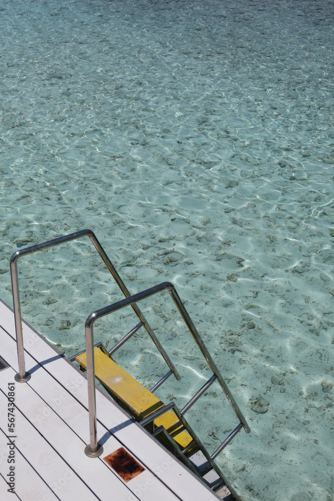 Swimming ladder from stainless steel for descent into sea water on pier. Swimming ladder from stainless steel for descent into sea water on pier.