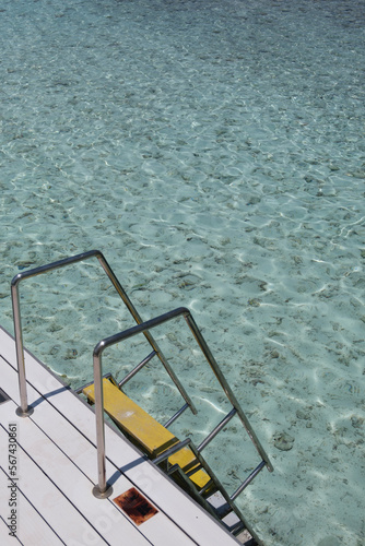 Swimming ladder from stainless steel for descent into sea water on pier. 