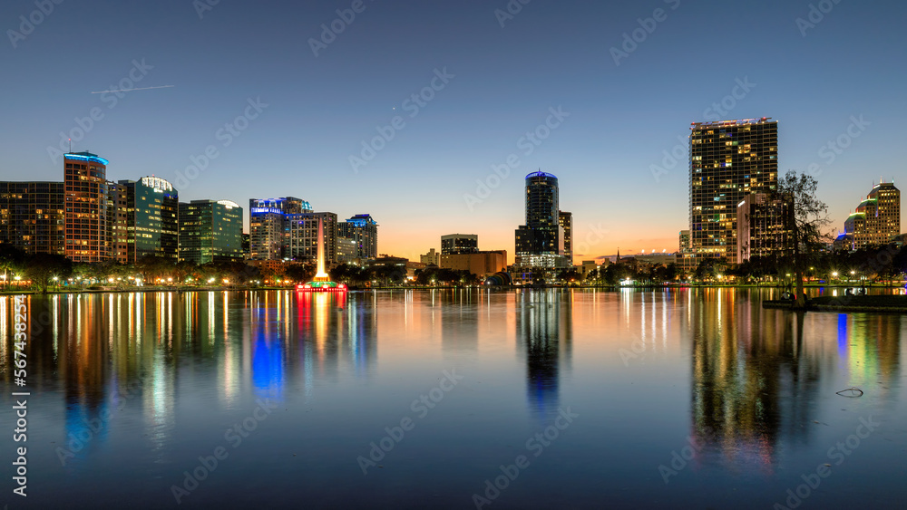Orlando city skyline at sunset in Lake Eola Park with fountain, Florida, USA