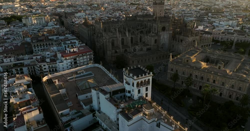 Flying Towards Catedral de Sevilla In Seville, Spain At Sunrise - drone shot Flying Towards Catedral de Sevilla In Seville, Spain At Sunrise - drone shot