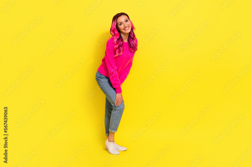 Full length photo of dreamy cute girl dressed vibrant pullover smiling isolated yellow color background Full length photo of dreamy cute girl dressed vibrant pullover smiling isolated yellow color background