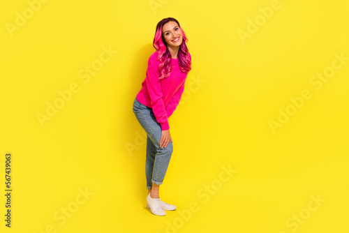 Full length photo of dreamy cute girl dressed vibrant pullover smiling isolated yellow color background © deagreez