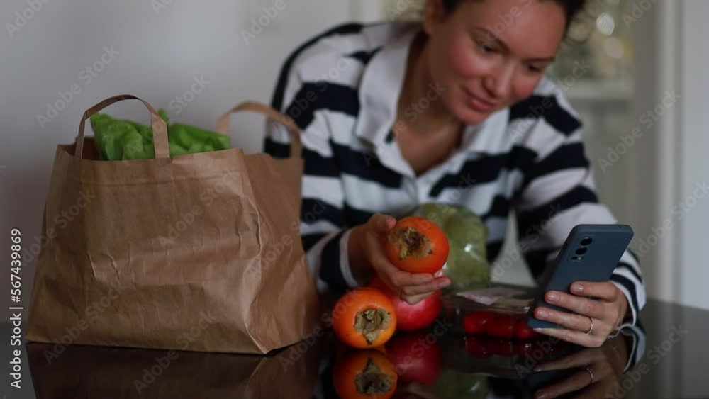 fresh food on the table, the girl uses the phone. 