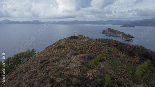 A man on top of an Kizil Ada island looks out into the Mediterranean sea from a drone.