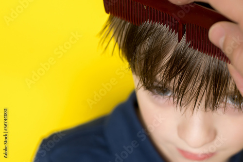 a little boy's hair is being combed. preparation for haircut