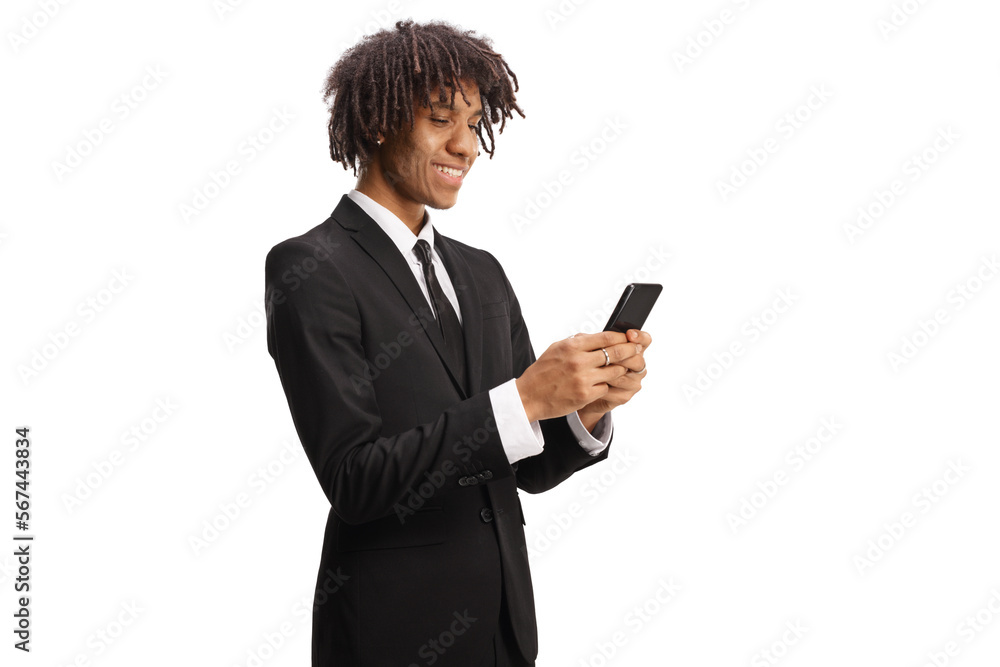 African american young businessman in a suit using a smartphone and smiling African american young businessman in a suit using a smartphone and smiling