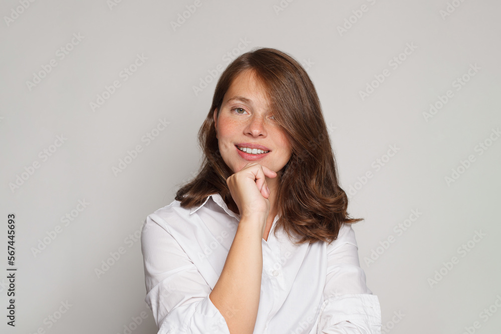 Portrait of beautiful nurse or doctor posing confidently while standing against white background Portrait of beautiful nurse or doctor posing confidently while standing against white background