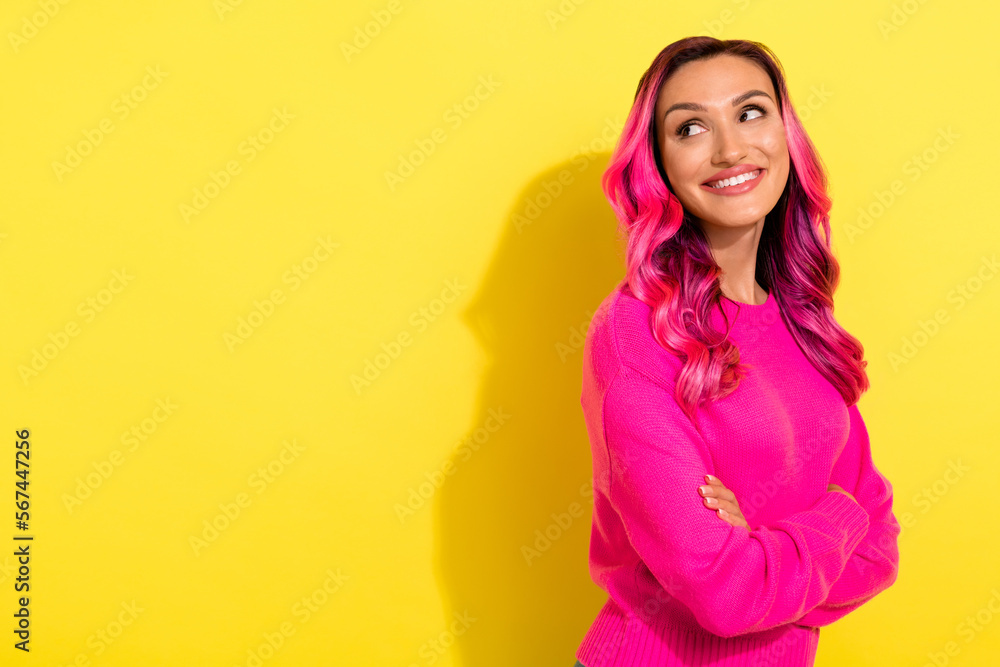 Photo of curious millennial lady crossing arms look empty space advertise coloring hair offer isolated on yellow background Photo of curious millennial lady crossing arms look empty space advertise coloring hair offer isolated on yellow background