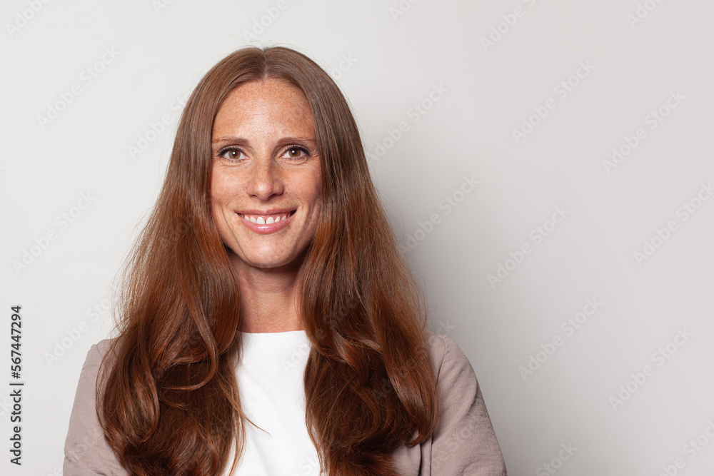 Fototapeta premium Happy smiling confident mid adult woman portrait. Beautiful female face closeup.