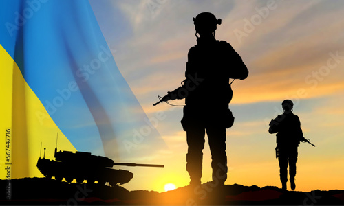 Silhouettes of a soldiers and a main battle tank on a battlefield with Ukraine flag against the sunset. EPS10 vector