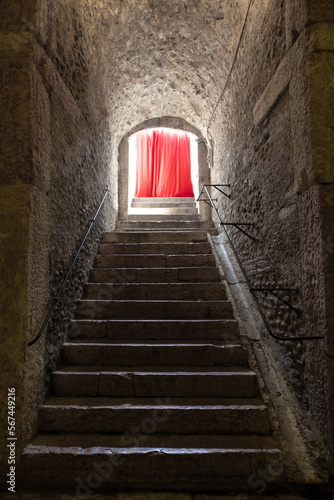 Old corridor with red curtain at the end. Concept for mystery  gothic  escape  hope.