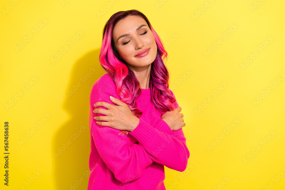 Photo of pretty tender lady closed eyes hands hug shoulders isolated on yellow color background Photo of pretty tender lady closed eyes hands hug shoulders isolated on yellow color background