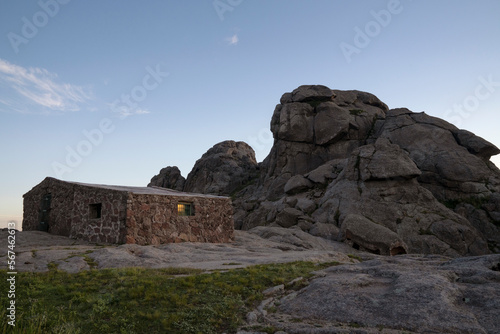Refuge Nores in the top of The Giants rock massif in Cordoba, Argentina. View of the rocky hill, house and sky at nightfall. 