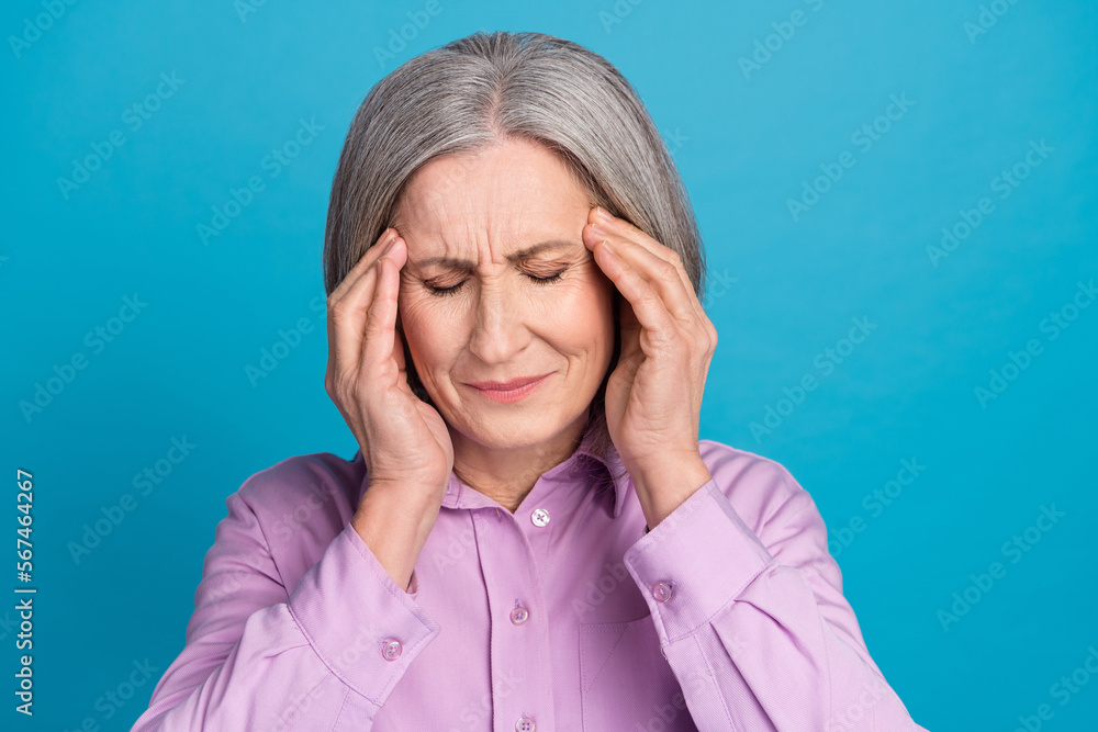 Photo portrait of retired old aged business lady bob grey hair grandmother forgot about deadline hands headache isolated on blue color background Photo portrait of retired old aged business lady bob grey hair grandmother forgot about deadline hands headache isolated on blue color background