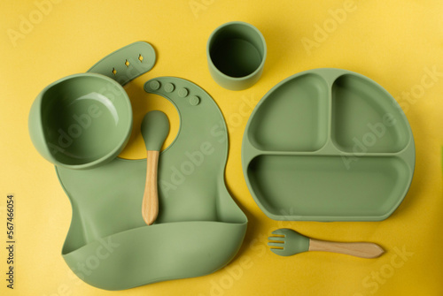 A set of children's silicone dishes. Baby feeding and nutrition concept. Top view, flat lay.