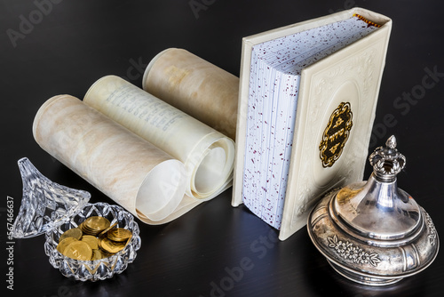 Siddur [Jewish prayer book], scroll [Torah, Megillah], Tzedakah [money box] photo