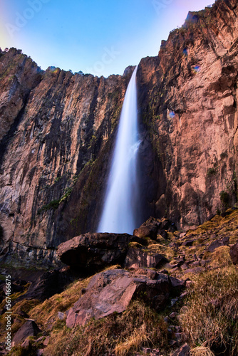 view from down of waterfall in sunset with purpple and blue colors, high wall of stone in basaseachi chihuahua