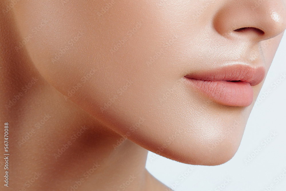 Lips of young beautiful woman closeup. Clean skin, nude makeup Lips of young beautiful woman closeup. Clean skin, nude makeup