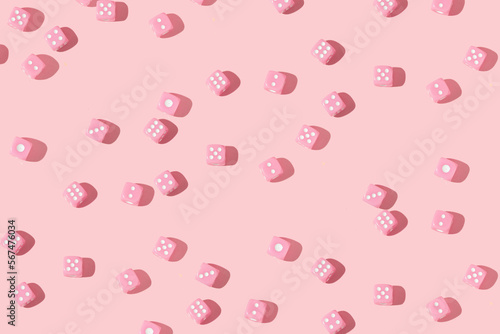 Romantic creative pattern with baby pink dices on pastel pink background. 80s or 90s retro fashion aesthetic love concept. Minimal romantic idea.
