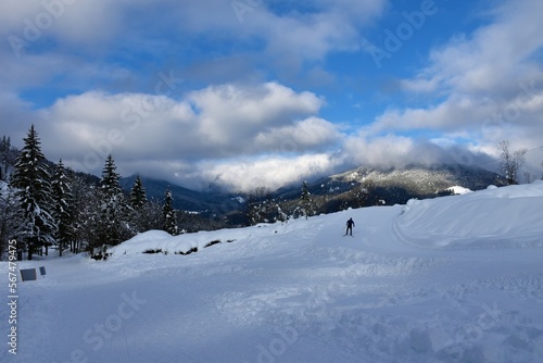 Cross-country skiing trail in Planica near Ratece in Gorenjska, Slovenia with forest covered hills in karavanke mountains