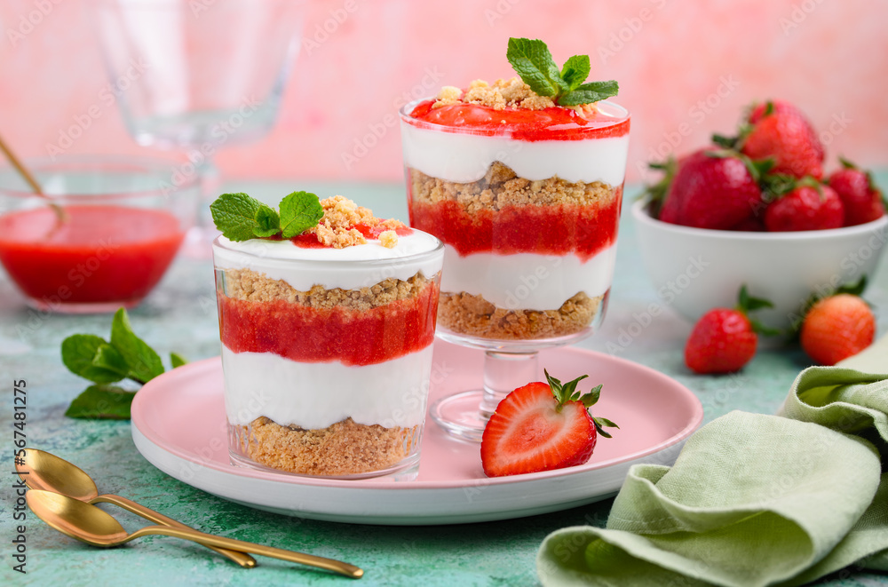 Crispy creamy strawberry trifle.  Summer dessert of shortbread crumbs, yogurt quark cream and strawberries. Selective focus