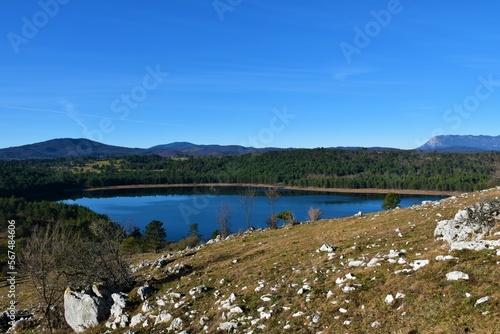 View of Petelinjsko jezero intermittent lake in Notranjska, Slovenia and Nanos mountain in the background photo