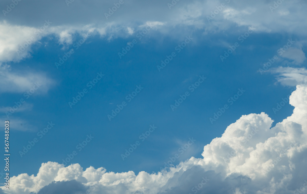 Interesting scattered clusters of clouds in a blue sky on a sunny day with cumulus and cirrus clouds