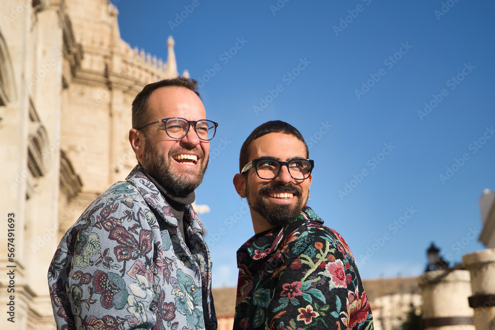 Real marriage of gay couple, laughing very happy and funny, looking distracted. Concept lgtb, lgtbiq+, couples, in love, love.