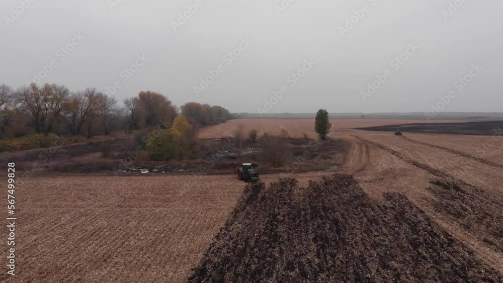 Tractor working in the field. Autumn tillage. Deep ripping with powerful tractor Tractor working in the field. Autumn tillage. Deep ripping with powerful tractor
