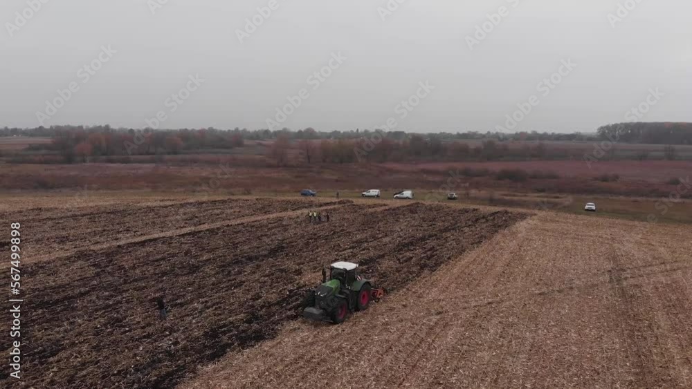 Tractor working in the field. Autumn tillage. Deep ripping with powerful tractor Tractor working in the field. Autumn tillage. Deep ripping with powerful tractor