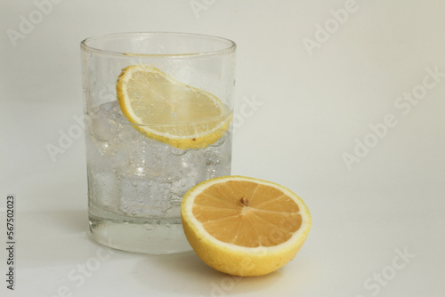 A Glass of Soda and A Section of Yellow Lemon