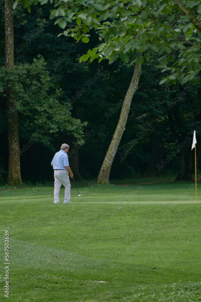 Person playing golf on the grass Person playing golf on the grass